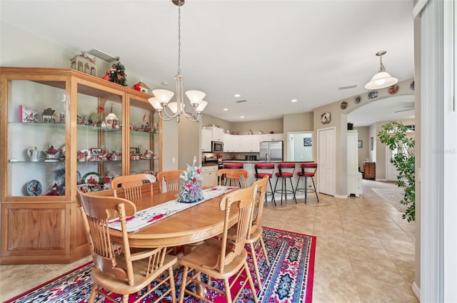 tiled dining area with a chandelier