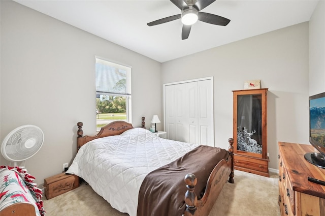 bedroom featuring light carpet, a closet, and ceiling fan