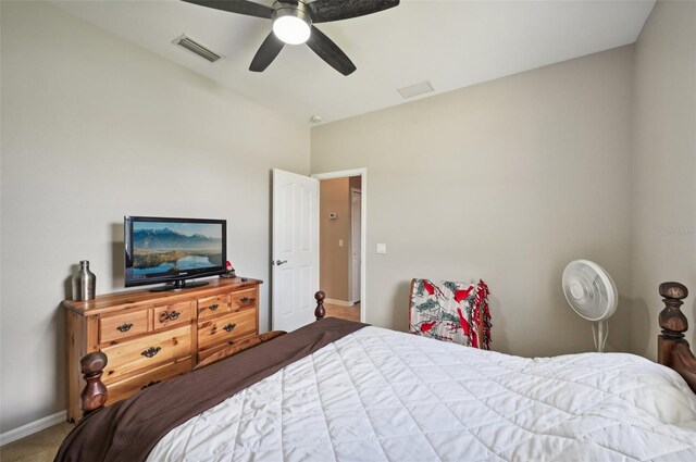 carpeted bedroom with vaulted ceiling and ceiling fan