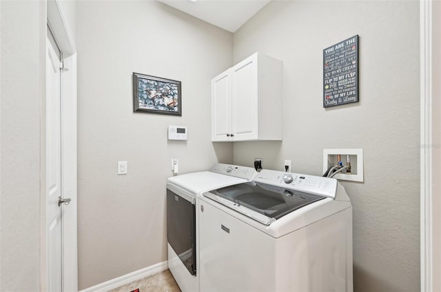 clothes washing area with cabinets, independent washer and dryer, and light tile patterned flooring