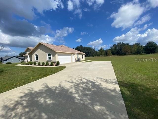 view of home's exterior featuring a lawn and a garage