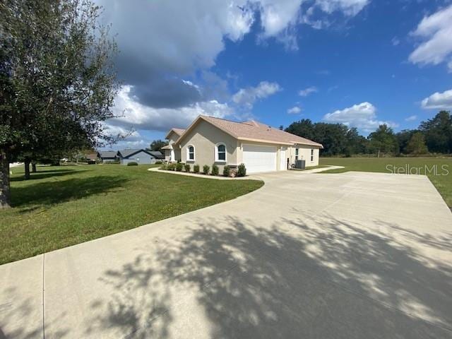 view of side of home with a garage and a lawn