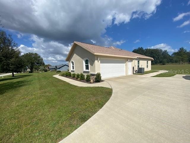 view of property exterior with a lawn, cooling unit, and a garage