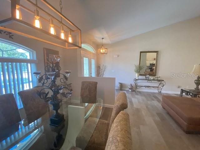 dining area featuring lofted ceiling and hardwood / wood-style floors