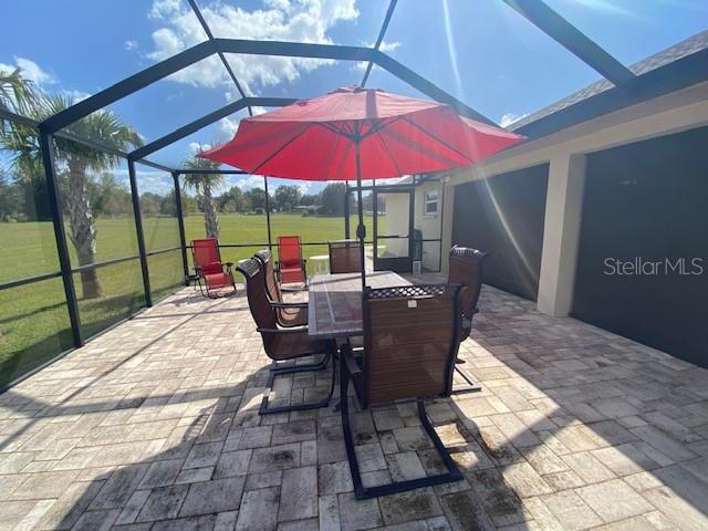 view of patio / terrace featuring a lanai