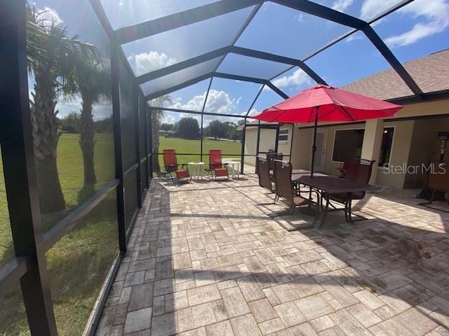 view of patio / terrace featuring a lanai