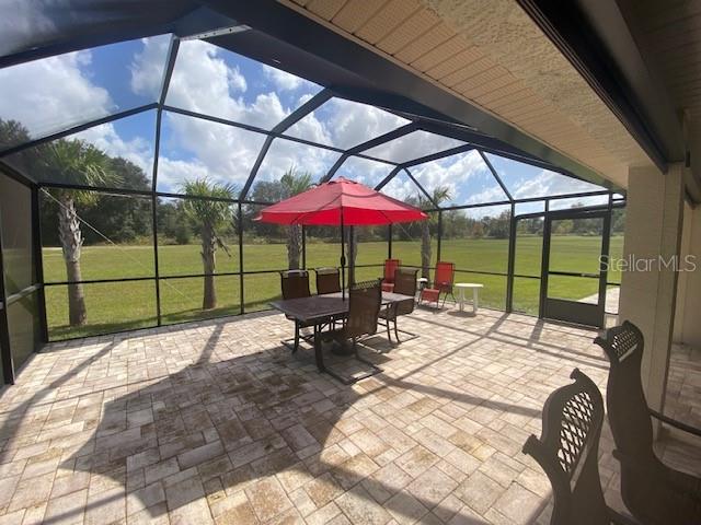 view of patio / terrace featuring a lanai