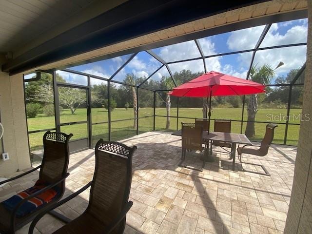 view of patio / terrace featuring a lanai