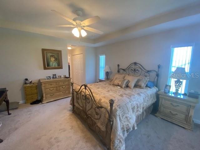 bedroom with a closet, ceiling fan, and carpet