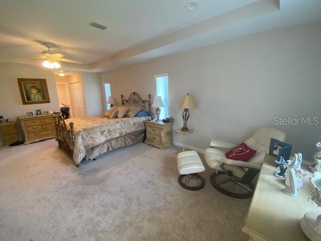 carpeted bedroom featuring a closet and ceiling fan