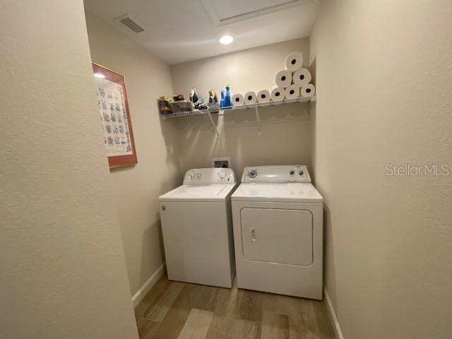 laundry area featuring separate washer and dryer and light wood-type flooring