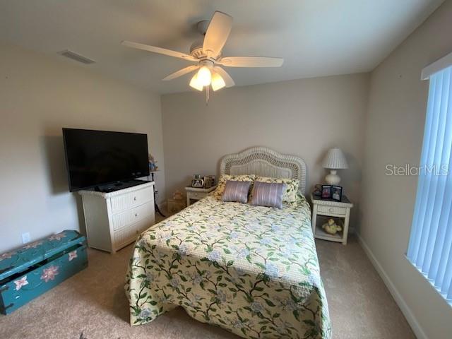 carpeted bedroom featuring ceiling fan