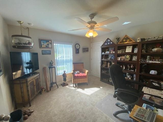 carpeted office featuring ceiling fan