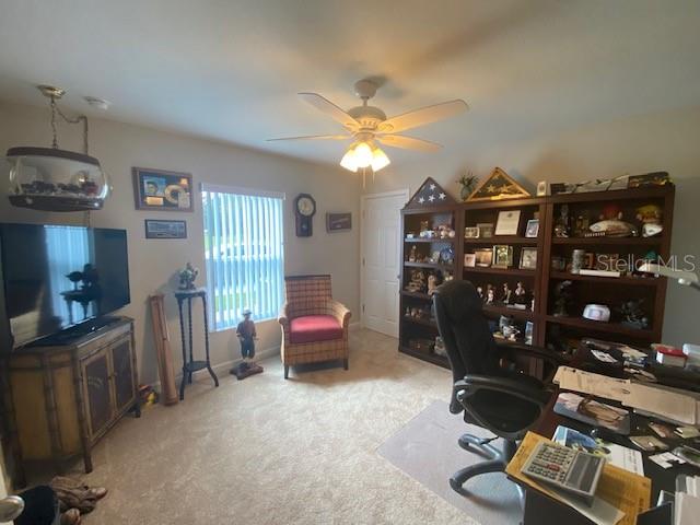 home office with light colored carpet and ceiling fan