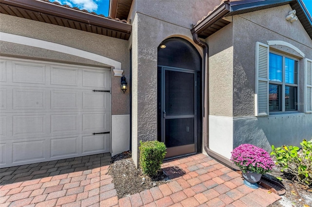 view of exterior entry featuring a garage