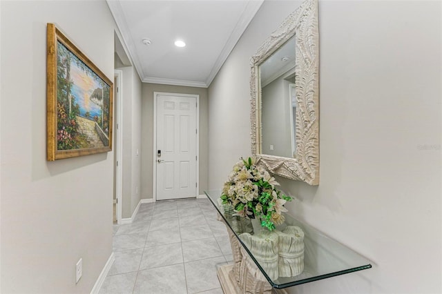 hallway with ornamental molding and light tile patterned floors