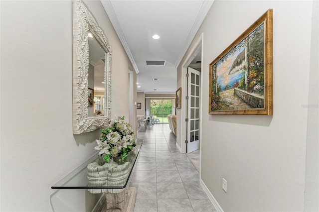 corridor featuring ornamental molding, light tile patterned floors, and french doors