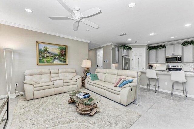 living room with ceiling fan and ornamental molding