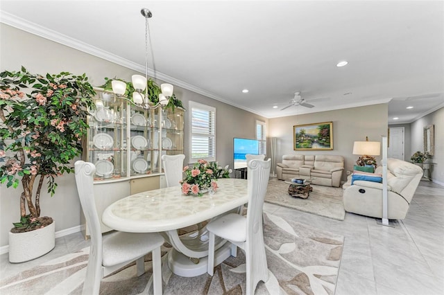 dining space featuring ceiling fan with notable chandelier and crown molding