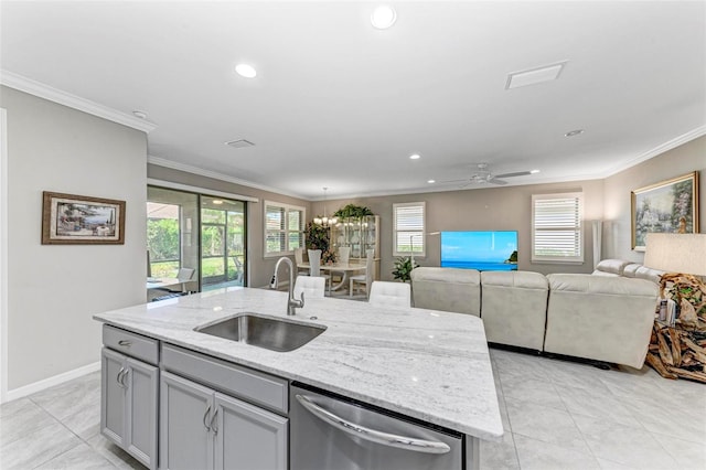 kitchen with dishwasher, a kitchen island with sink, sink, ceiling fan, and light stone countertops