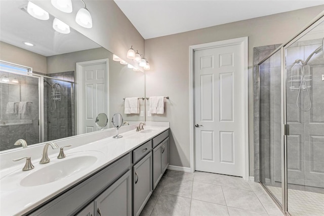 bathroom with tile patterned flooring, vanity, and walk in shower