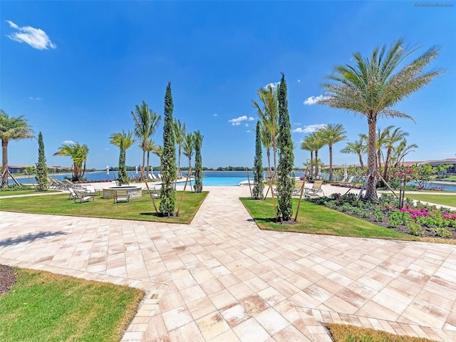 surrounding community featuring a yard and a water view