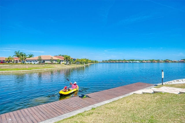 dock area featuring a yard and a water view