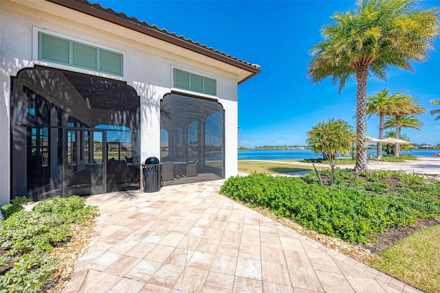 view of community with a water view and a patio area