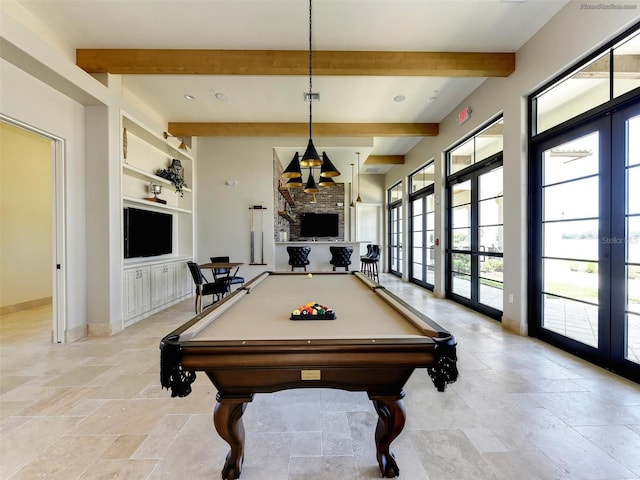 recreation room with french doors, a stone fireplace, billiards, built in shelves, and beamed ceiling