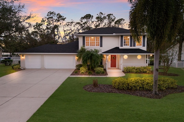 view of front of house with a porch, a yard, and a garage