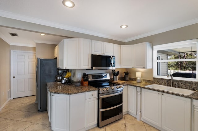 kitchen with sink, white cabinetry, stainless steel appliances, and dark stone countertops