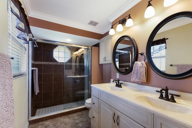 bathroom featuring tile patterned floors, toilet, crown molding, vanity, and an enclosed shower