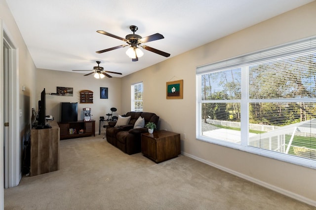 carpeted living room featuring a healthy amount of sunlight and ceiling fan