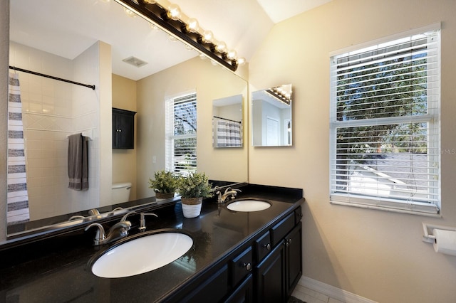 bathroom with vanity, curtained shower, and toilet