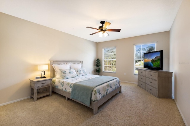 bedroom featuring light colored carpet and ceiling fan