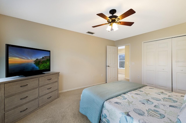 bedroom with light carpet, a closet, and ceiling fan