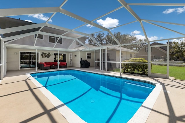 view of pool featuring outdoor lounge area, a patio area, and a lanai