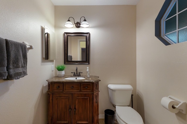 bathroom with toilet and vanity