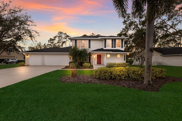 front of property featuring a garage and a lawn