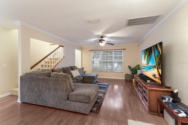 living room featuring crown molding, dark hardwood / wood-style floors, a textured ceiling, and ceiling fan