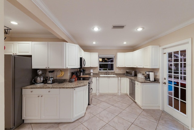 kitchen featuring light stone countertops, sink, appliances with stainless steel finishes, and white cabinets