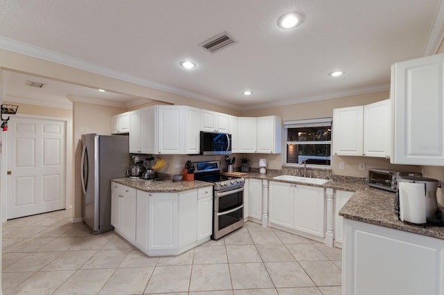 kitchen with stainless steel appliances, ornamental molding, sink, light tile patterned flooring, and white cabinetry