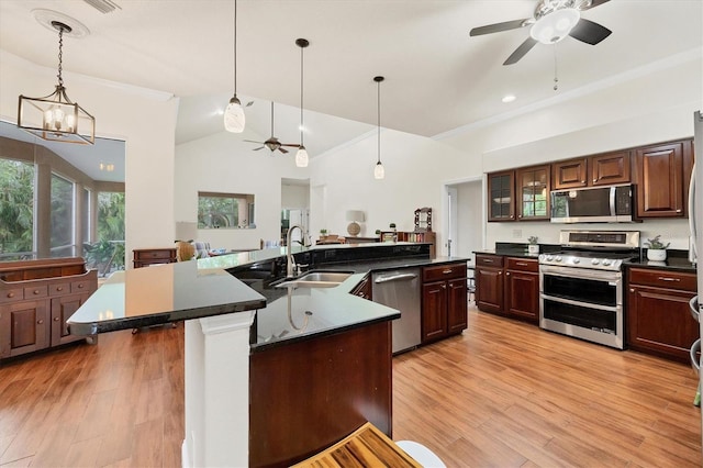 7341 Featherstone Blvd, Sarasota, FL 34238 - kitchen with appliances with stainless steel finishes, a sink, ceiling fan, dark countertops, and crown molding