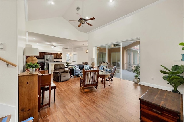 living room featuring ornamental molding, high vaulted ceiling, and light wood-type flooring