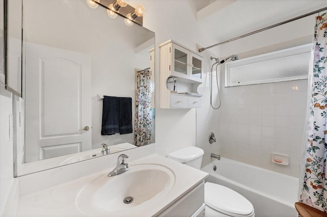 full bathroom with toilet, shower / bath combo with shower curtain, and vanity