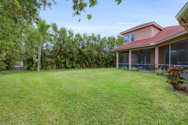 7341 Featherstone Blvd, Sarasota, FL 34238 - view of grassy yard with a sunroom and ceiling fan