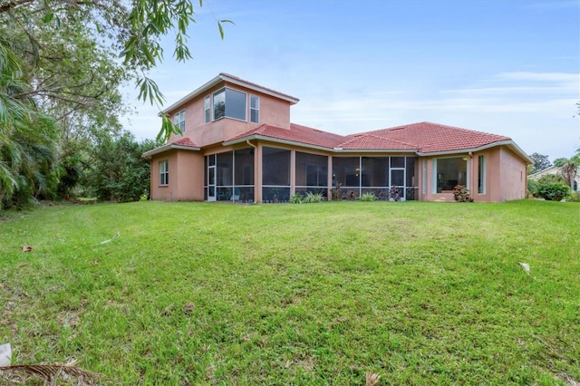 7341 Featherstone Blvd, Sarasota, FL 34238 - rear view of property featuring a sunroom, a lawn, and stucco siding