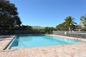 7341 Featherstone Blvd, Sarasota, FL 34238 - community pool with a patio area and fence