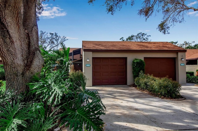 view of front of property featuring a garage and an outdoor structure