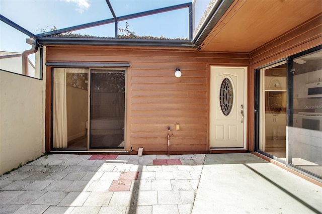 entrance to property featuring a patio area